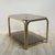 This nightstand features a brass frame with two smoked glass plates.