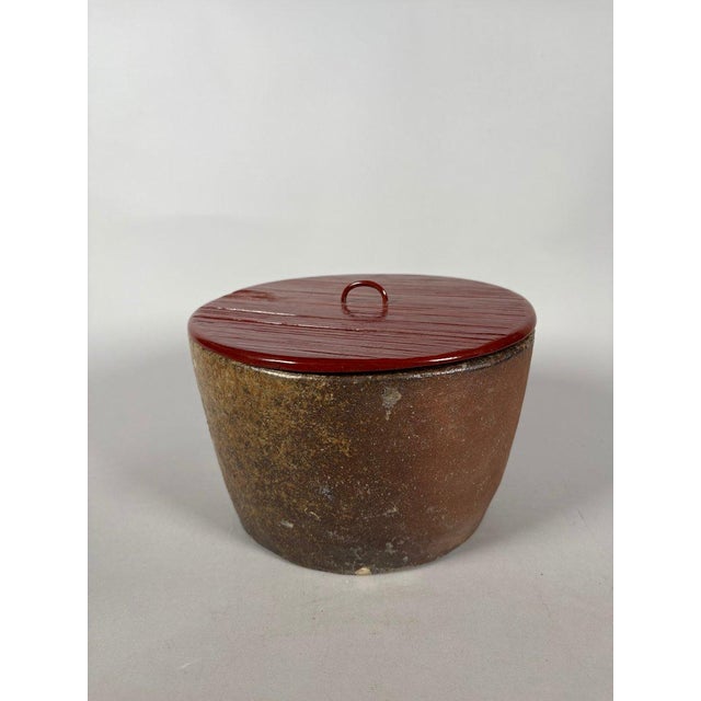 A glazed stoneware water vessel with a lacquered lid, Japan, Edo period (1615-1868). The round, flared water vessel (used...