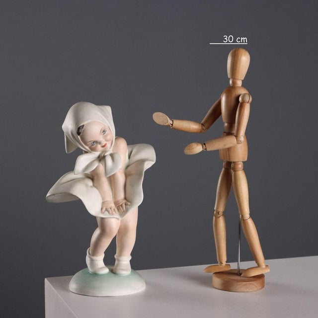 Gust of Wind, cast ceramic statue. The artist's signature is engraved on the base. This piece is attributed to the...