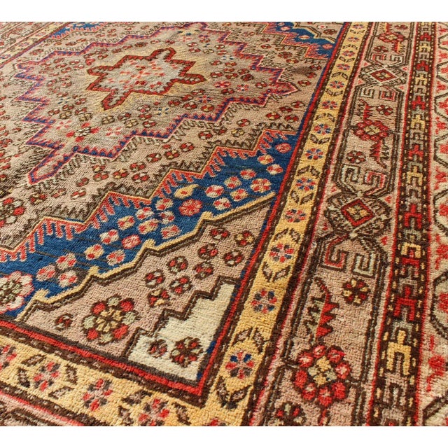 Colorful Antique Khotan Rug With Multi Layered Medallion. Taupe background antique Khotan rug with repeating layered...