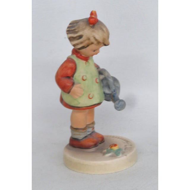 This darling Young Girl Figurine is made of porcelain. This charming Hummel figurine titled "Little Gardener" is a...
