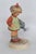 This darling Young Girl Figurine is made of porcelain. This charming Hummel figurine titled "Little Gardener" is a...