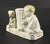 A lovely fairing porcelain figural match holder It features a baby and a puppy, both very cute, seating next to a large...