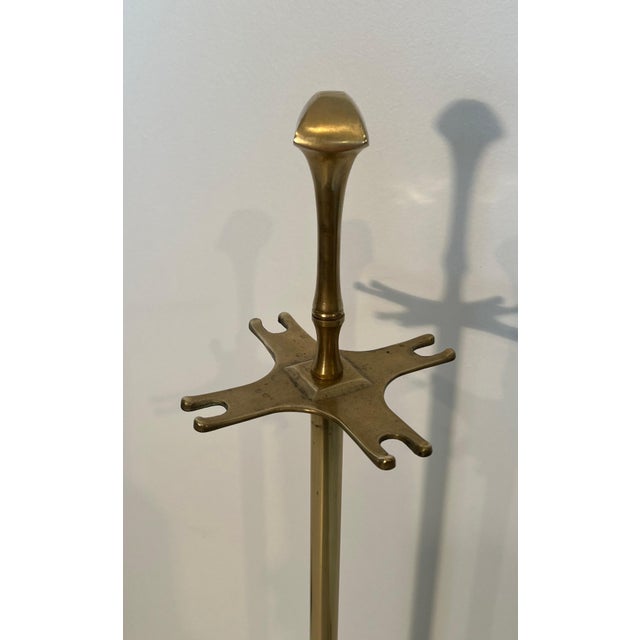 These neoclassical style fireplace tools are made of brass. This is a French work. Circa 1970