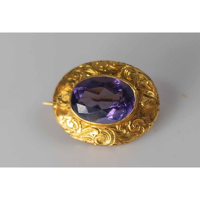 We are selling this very pretty Victorian Gold pin. This pin has simple yellow gold body with incised decoration around a...