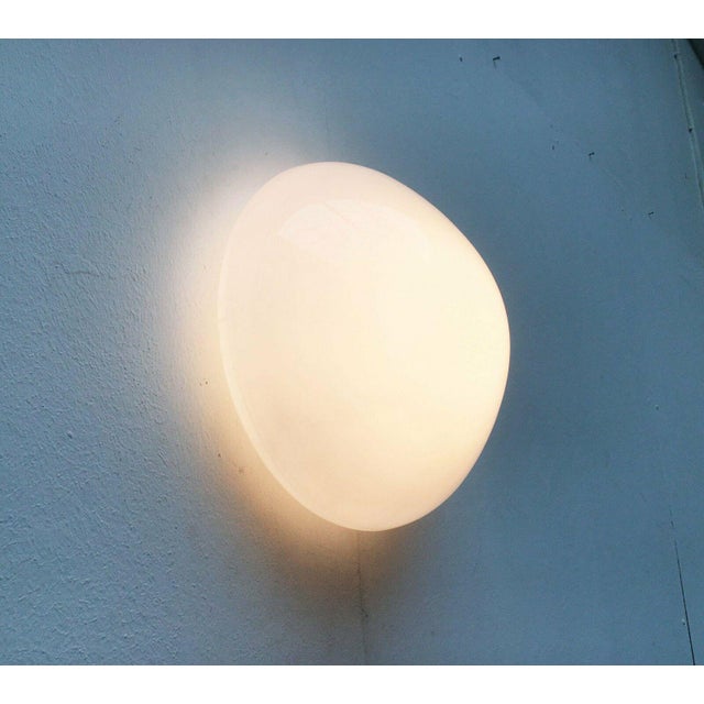 Classic ceiling or wall light after a design by Wilhelm Wagenfeld from the 1950s. A functional, elegant and therefore...