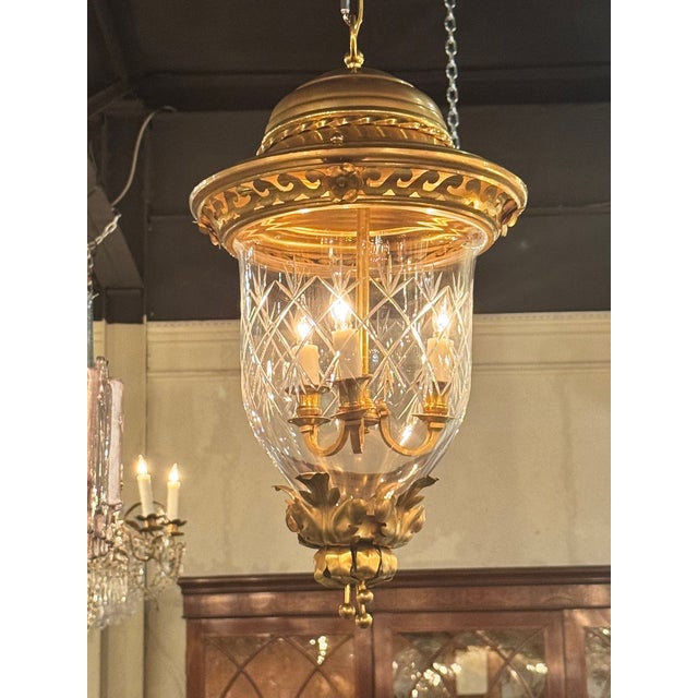 The product is a pair of French gilt tole lanterns, which are decorative lighting fixtures. These lanterns are designed...