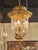 The product is a pair of French gilt tole lanterns, which are decorative lighting fixtures. These lanterns are designed...