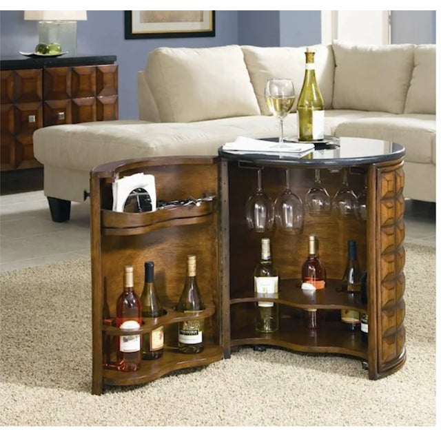 Sculptural Mid-Century Modern drum-form dry bar featuring a bold, geometric carved walnut exterior and polished black...