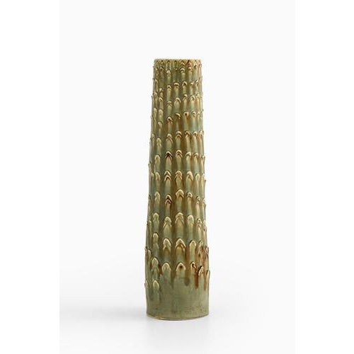 This unique floor vase, designed by Carl-Harry Stålhane and produced by Rörstrand in Sweden in 1949, stands as a striking...