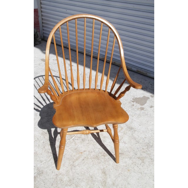 A Late 20th Century Amish crafted Oak Continuous Windsor Armchair with Spindle Back. A true definition of elegance and...