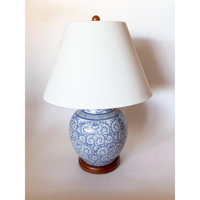 Absolutely lovely blue and white ginger jar lamp with blue vine and leaf motif by Ralph Lauren. It features a wooden base...
