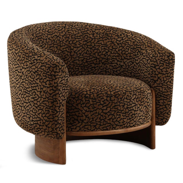 Modern stylish and bold barrel chair, featuring plush brown and black leopard-print polyester velvet upholstery paired...