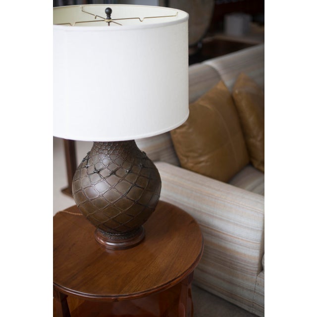 A beautiful brown bulbous lamp with a custom white linen shade. This lamp has been wired for the US with a brown braided...