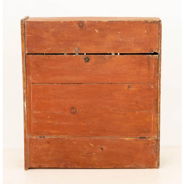 American Primitive White and Red Painted Pine Chest, 19th century, the drop front door opening to three-segmented storage...