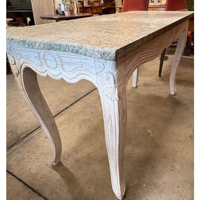 Wonderful Louis XV style console table with carved frame paired with a stunning marble top. The console table originated...