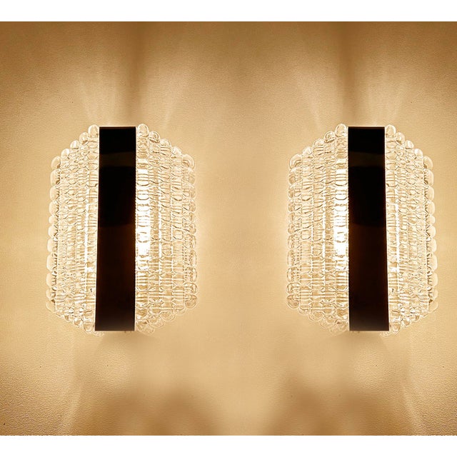 Pair of vintage mid century bubble glass sconces by Kaiser , featuring stepped bubble glass shade with a center chrome...