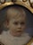 1901 portrait miniature of a child framed in a metal frame, probably intended to be a pendant worn on a chain around the...