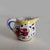 Vintage creamer pitcher A small white ceramic creamer pitcher with a design of yellow, red and blue. The base is stamped...