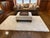 A custom, well-made two-seat sofa with a hardwood frame, classic rolled arms, loose down-filled cushions, and dressmaker...