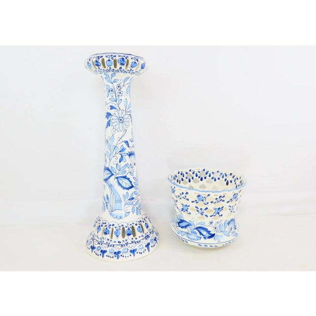 A fabulous 1970's 2-piece blue and white reticulated ceramic jardiniere / planter on fitted pedestal. Features hand-...