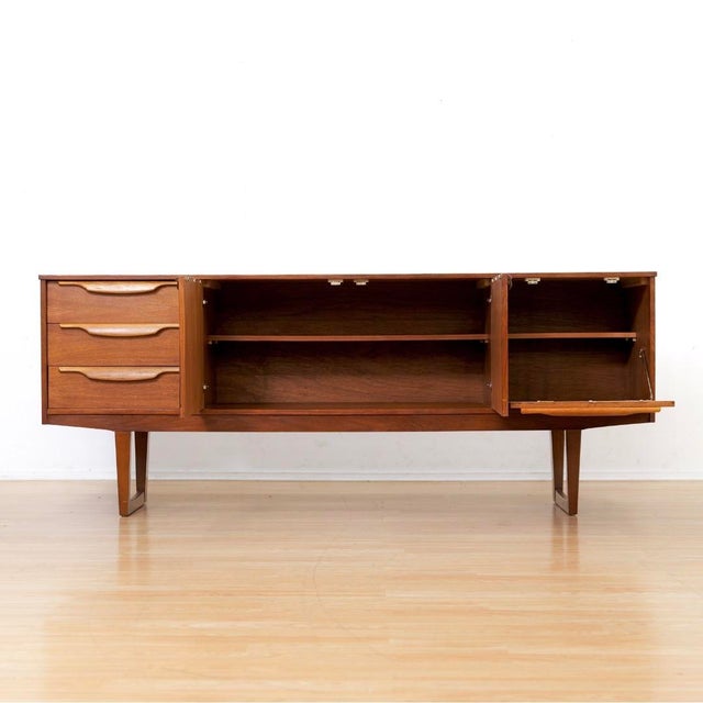 This vintage mid-century credenza was produced during the 1960s. A wonderful minimalist design and excellent storage piece...