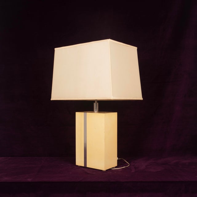 Overview Elegant table lamp designed by Tommaso Barbi in the 1970s, characterized by a refined geometric composition...