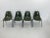Set of four dining chairs in pine green by Herman Miller. The chairs show traces of use like some scratches on the shells...