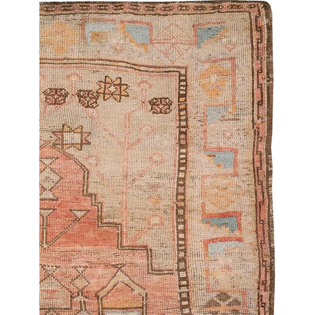 This mid-20th-century Turkish Anatolian small gallery carpet presents a vertically organized composition centered on a...