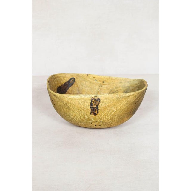 This hand-carved wooden bowl is made by the Turkana, a nomadic community in north-west Kenya prized for their woodcarving...