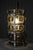 Venetian-style lamp made of blown glass in a metal cage, with dual lighting featuring two bayonet-base bulbs. The lamp is...