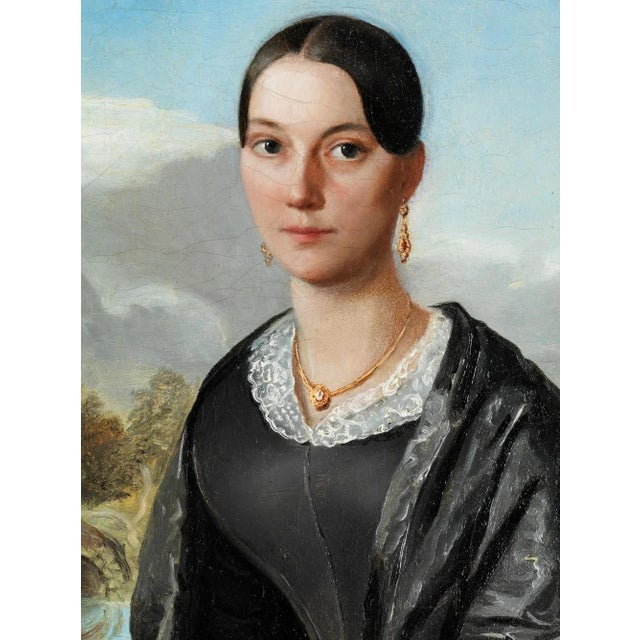 Inscribed on the reverse of the stretcher. A half-length portrait of a beautiful woman against a landscape that seems...