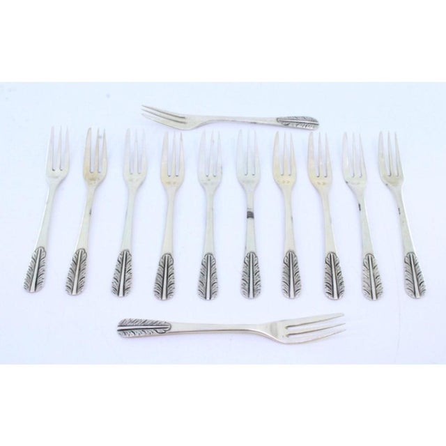 Silver Cake Forks with Handle Reliefs, Set of 12, in Very Good conditions. Designed 1890 to 1919 This piece has an...