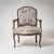 Elegant armchair in baroque style with curved wooden frame and floral upholstery in pastel shades. The frame has been...