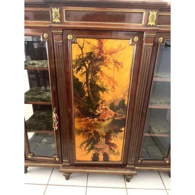 This antique French hand-painted cabinet is a superb piece of mahogany furniture with brass accents. The cabinet features...