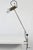 This model 255 clamp lamp in the style of radical design is an early model from a lighting series designed by Tito Agnoli...