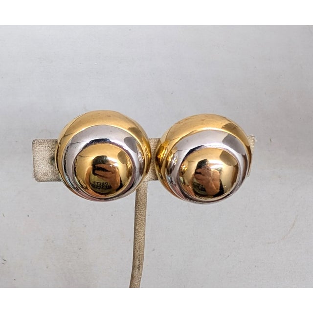 1980s goldtone and rhodium plated round domed "bulleye" clip earrings. Marked "LANVIN PARIS ©" on a cartouche on the back....