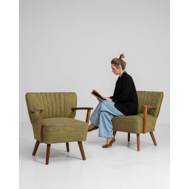 A refined pair of Danish mid-century modern armchairs, reflecting the clean lines and ergonomic design principles of...