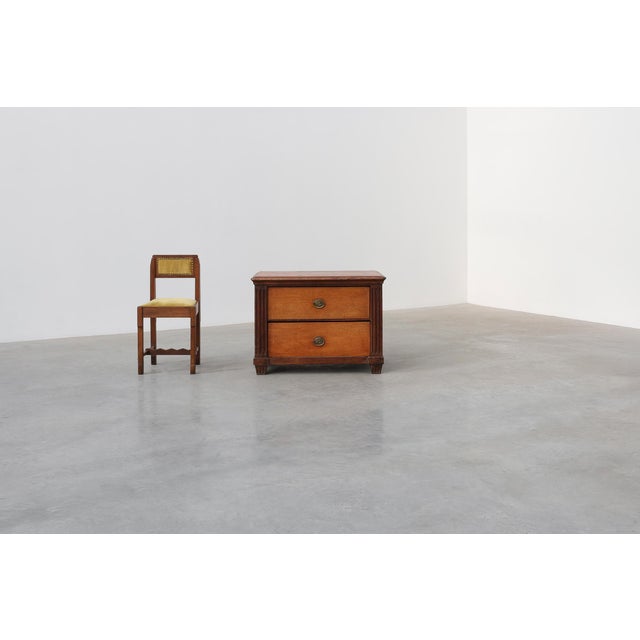 A charming french louis xvi commode crafted from solid oak, dating to around 1800. This compact chest of drawers showcases...