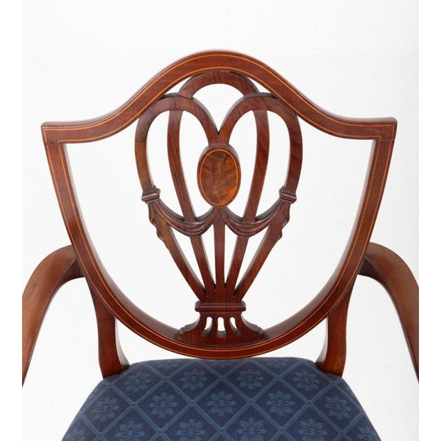 A very good set of twelve hepplewhite style mahogany dining chairs, comprising ten standard chairs and two elegant carvers...