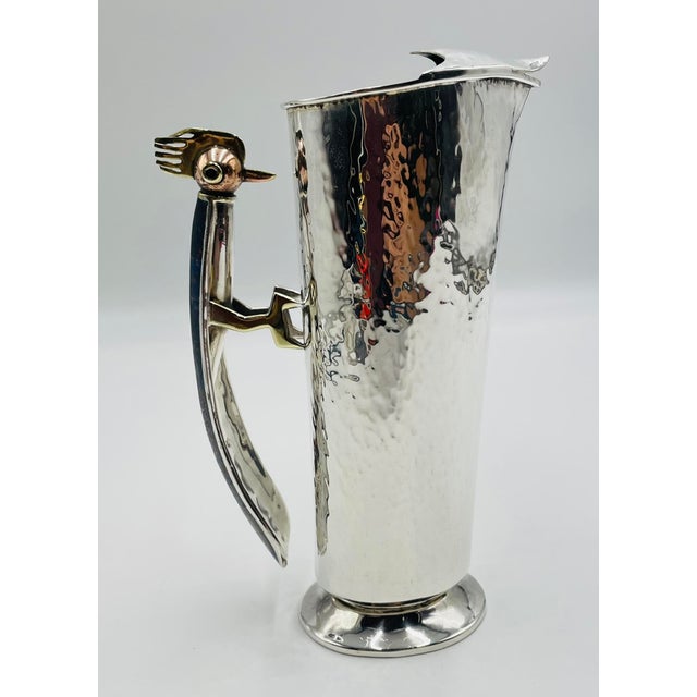 A whimsical and highly collectible silver-plated water pitcher designed and manufactured in Taxco, Mexico by the...