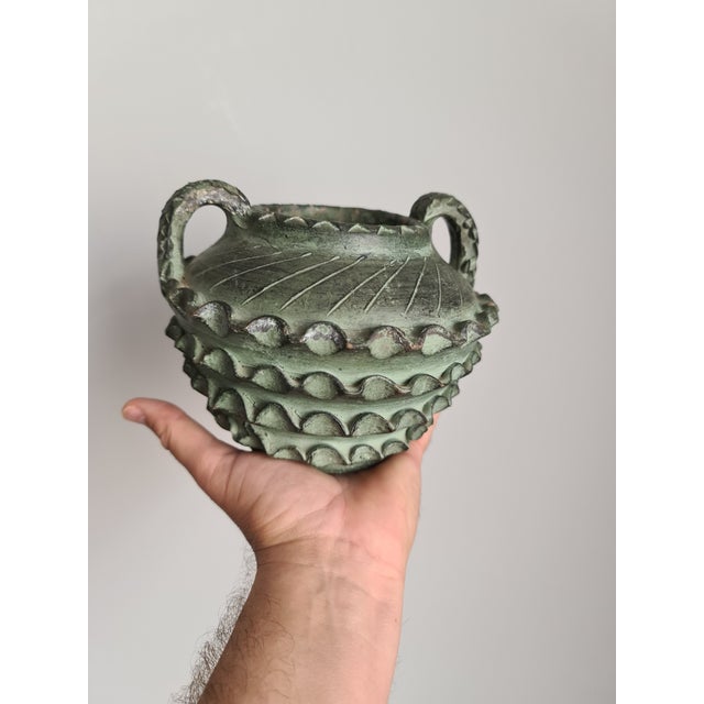 A stunning Spanish handcrafted vase with a powerful design, dating from the Mid-Century period, circa 1960. This piece...