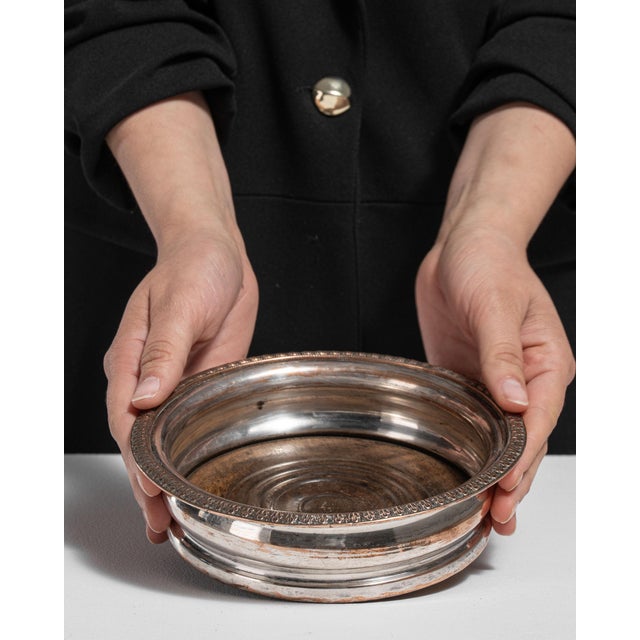 This early 20th century Victorian decorative object from United Kingdom is finished in silver. Its design carries the...