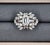 A striking 2.02-carat GIA-certified emerald-cut cornered rectangular step-cut diamond takes center stage, exhibiting a...