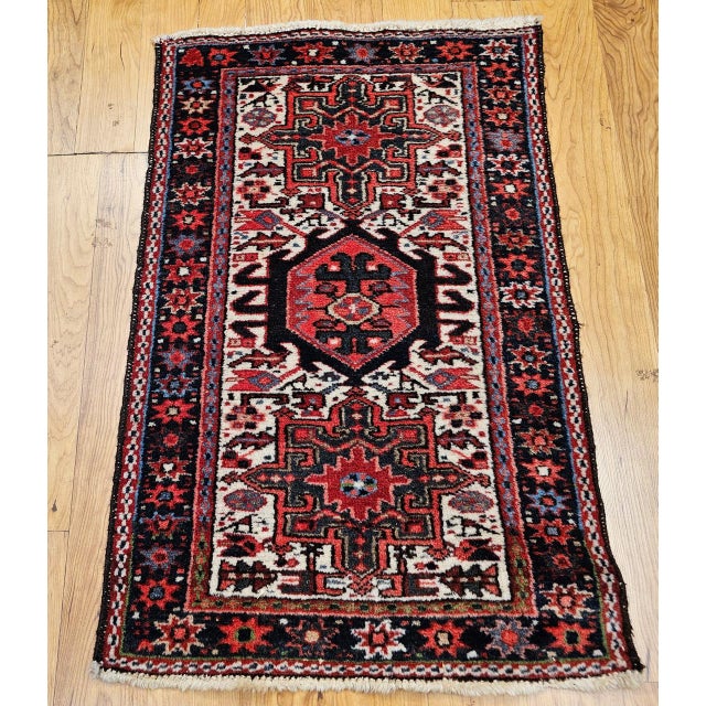 "This vintage Persian Heriz Karajeh area rug, hand-knotted in the second quarter of the 20th century, features the iconic...