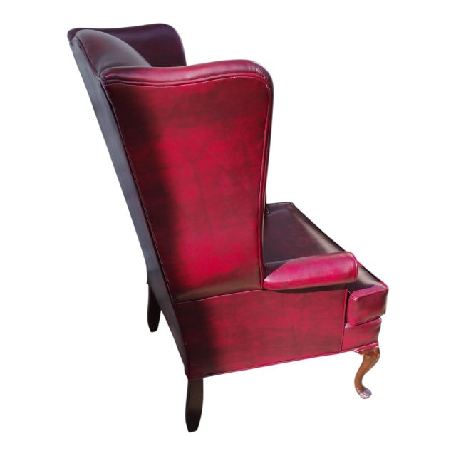 Vintage English Georgian-style wingback oxblood upholstery lounge chair & matching ottoman This vintage English Georgian-...