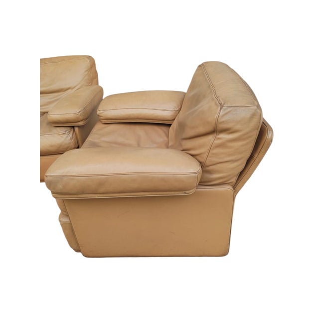 Complete living room set consisting of a three-seater sofa and a pair of beige leather armchairs with flat armrests, from...