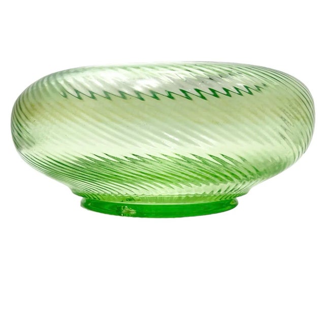 Add a fine art deco touch to your decor with this beautiful uranium glass bowl with a spiral optic pattern from the 1930s....