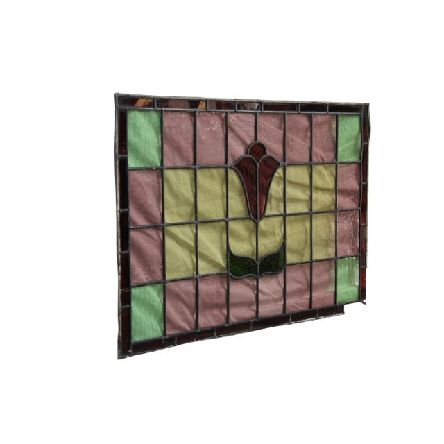 Exquisite antique Victrorian leaded stained glass window panel. Features a colorful patchwork pattern in rose, green in...