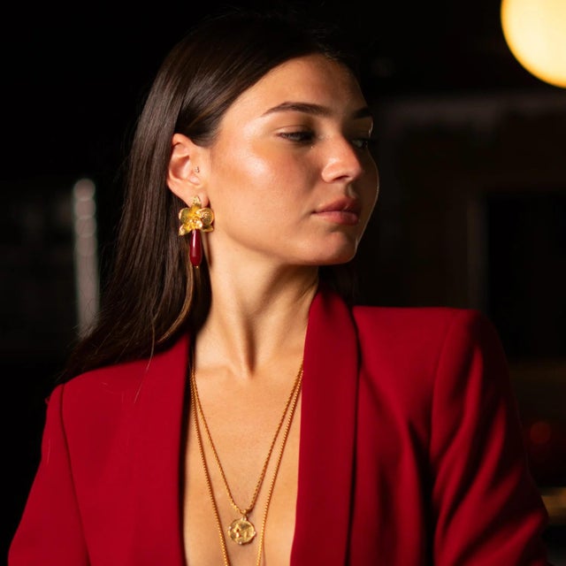 Bring a touch of bold elegance to your style with the Orchid Flame Red Agate Gold Earrings. Featuring a radiant orchid...